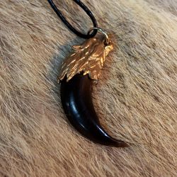 Talisman pendant wolf's claw in a bronze frame