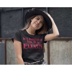 in a world full of tens, be an eleven womens t-shirt