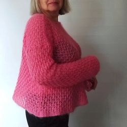 Knitted cropped jumper. Tunic of a direct silhouette from a thin mohair. Light and airy coral-colored womens pullover.