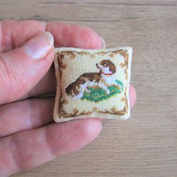 Embroidery kit for a miniature dollhouse pillow (red dog on a pillow) in 1/12 scale.