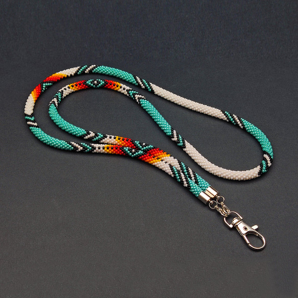 Vibrant turquoise beaded lanyard with Native American-inspired design