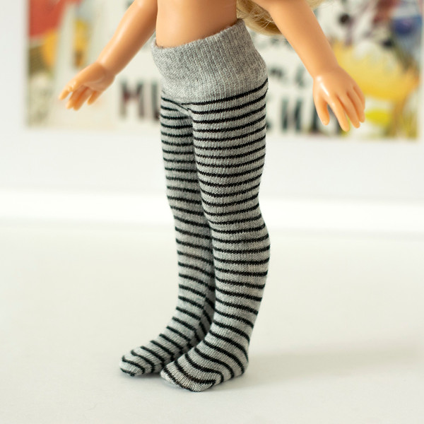 A 13-inch doll in handmade gray striped tights.