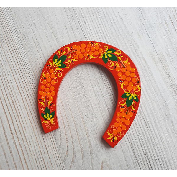 red souvenir wooden horseshoe hand-painted