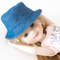 A 14-inch doll Ruby Red Fashion Friends in a handmade blue denim panama hat