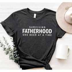 surviving fatherhood shirt,dad shirt,father's day gift,funny dad t-shirt,gifts for dad,husband gift,dad tee,dad clothing