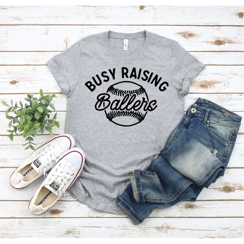 MR-2952023192235-busy-raising-ballers-shirt-mom-life-baseball-mom-softball-image-1.jpg