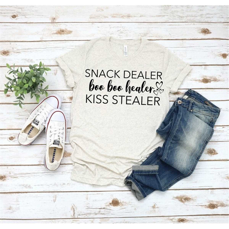 MR-2952023211230-snack-dealer-boo-boo-healer-kiss-stealer-shirt-mom-life-image-1.jpg