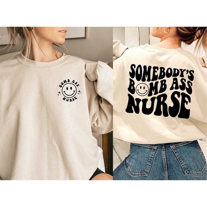 MR-162023164844-somebodys-bomb-ass-nurse-sweatshirt-cute-smiley-face-image-1.jpg
