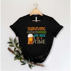 surviving fatherhood one beer at a time shirt, funny papa shirt, funny dad life tee daddy gifts, best father shirt, papa