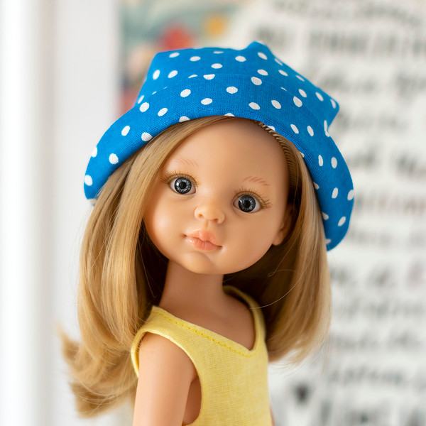 A 13-inch doll in a handmade polka dot panama hat