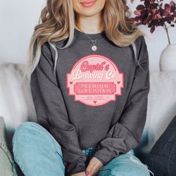 cupid's brewing co sweater, valentine sweatshirt, premium love potions, cupid sweatshirt, brewing co sweatshirt, valenti