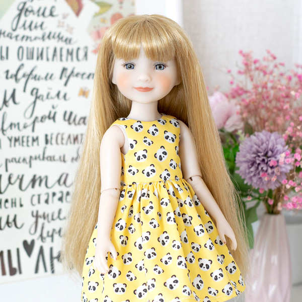 A Ruby Red doll in a yellow dress with a print of cute little pandas