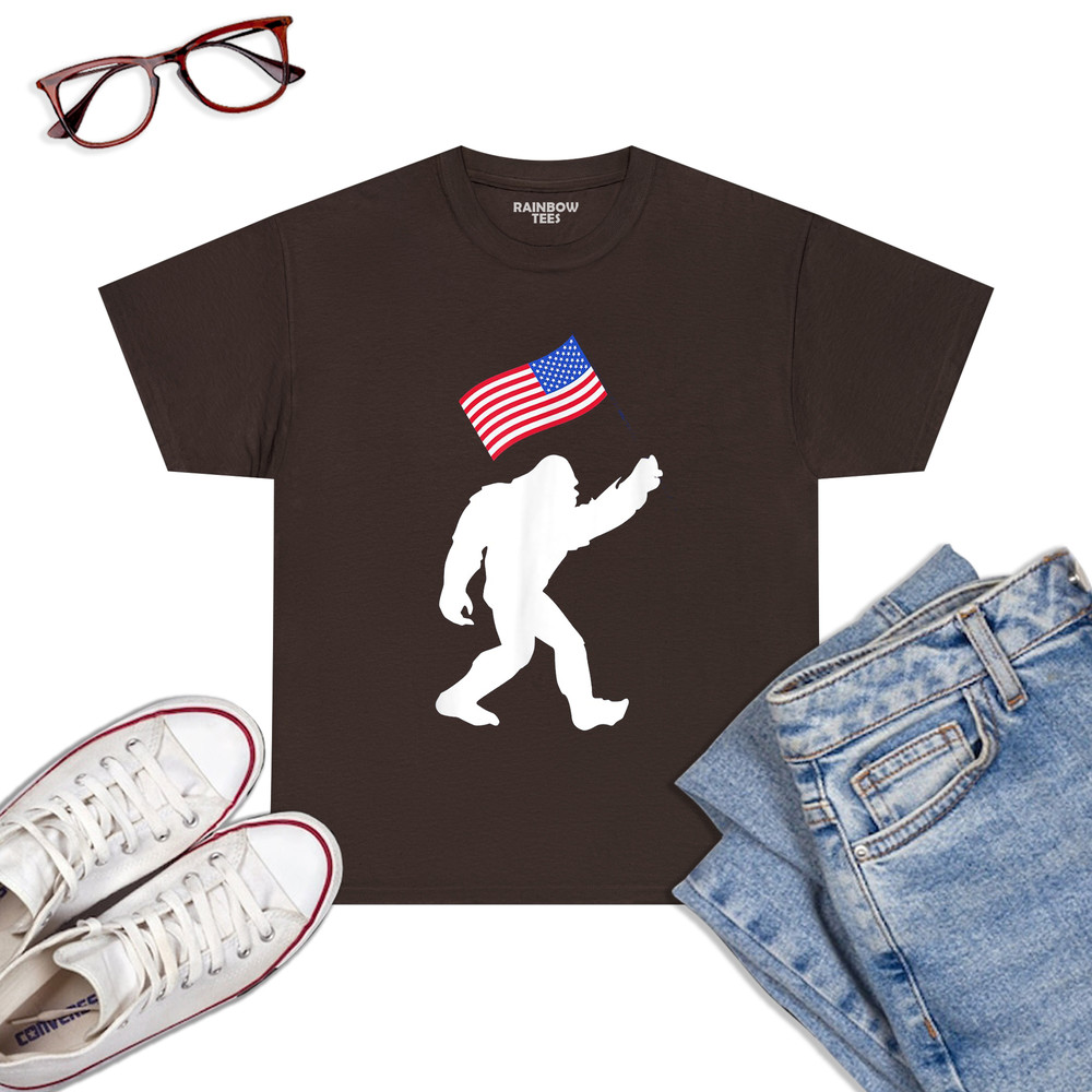 Bigfoot-With-American-Flag-Funny-4th-Of-July-T-Shirt-Dark-Chocolat.jpg