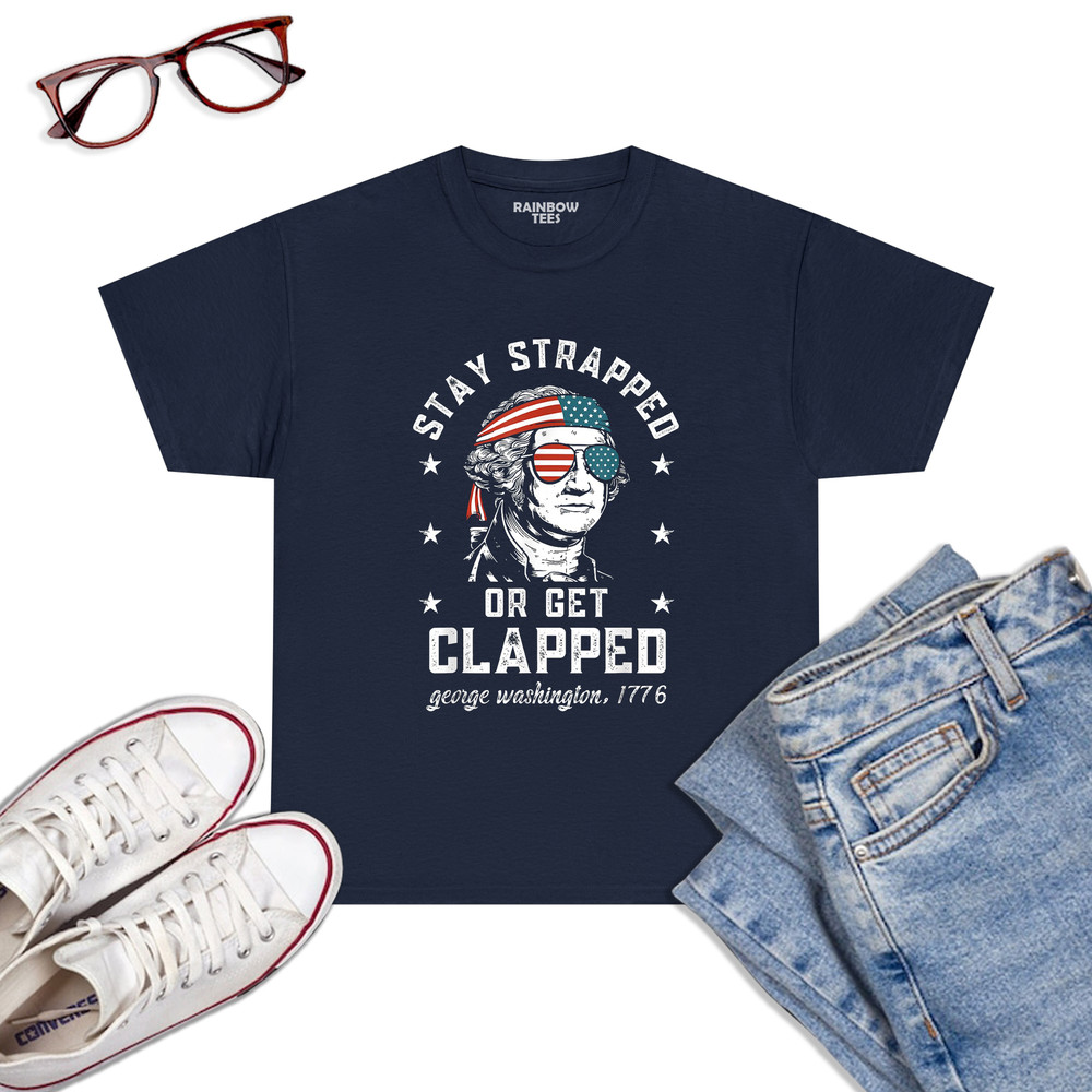 Stay-Strapped-Or-Get-Clapped,-George-Washington,4th-Of-July-T-Shirt-Navy.jpg