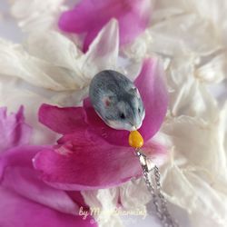 Gray hamster dwarf eats a corn seed It is tiny realistic figurine and It is cute memorial gift for owner who lost a pet