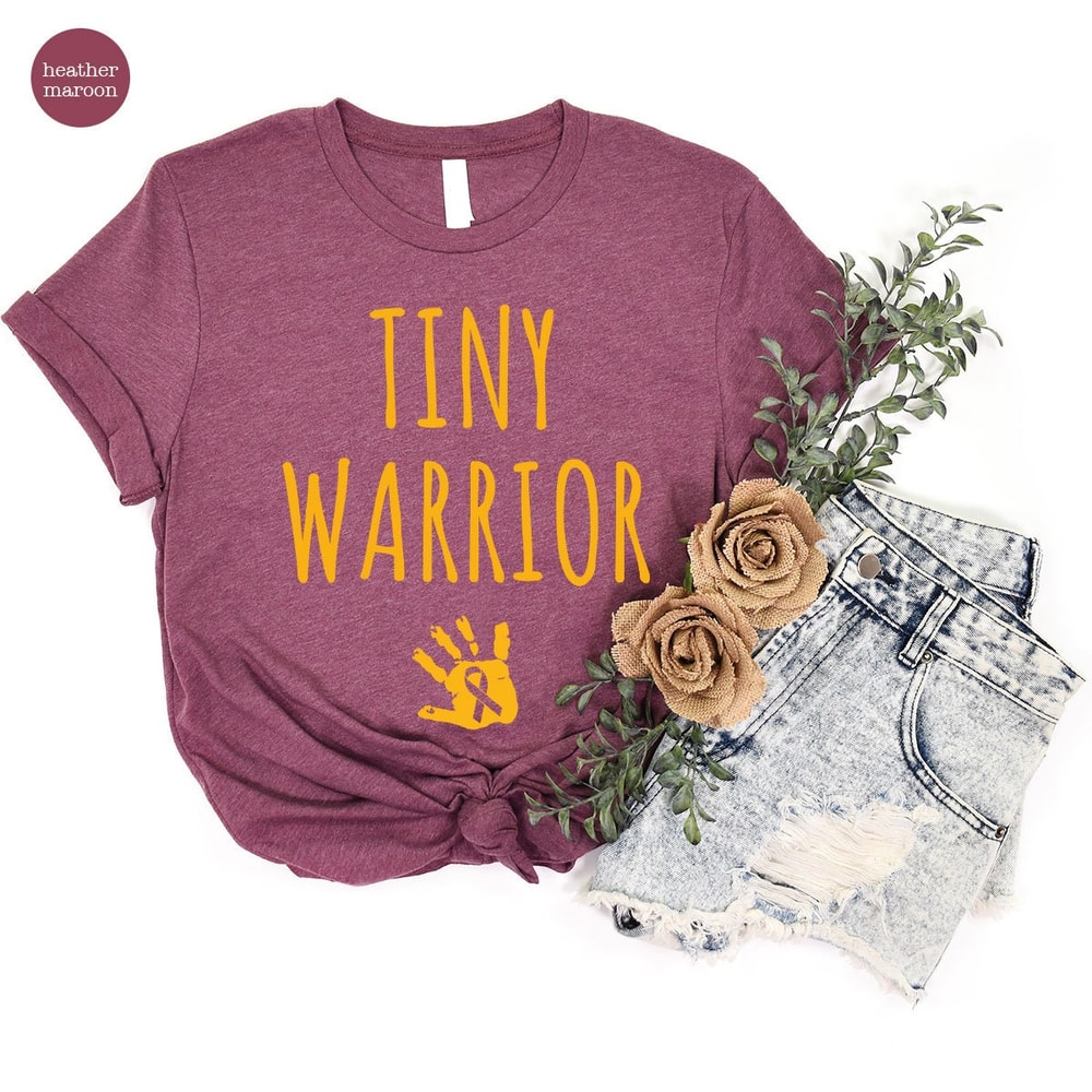 Tiny Warrior Gold Cancer Ribbon Graphic Tee, Childhood Cancer Crewneck Shirt, Mama of a Cancer Warrior Shirt, Pediatric Cancer Survivor Gift - 7.jpg