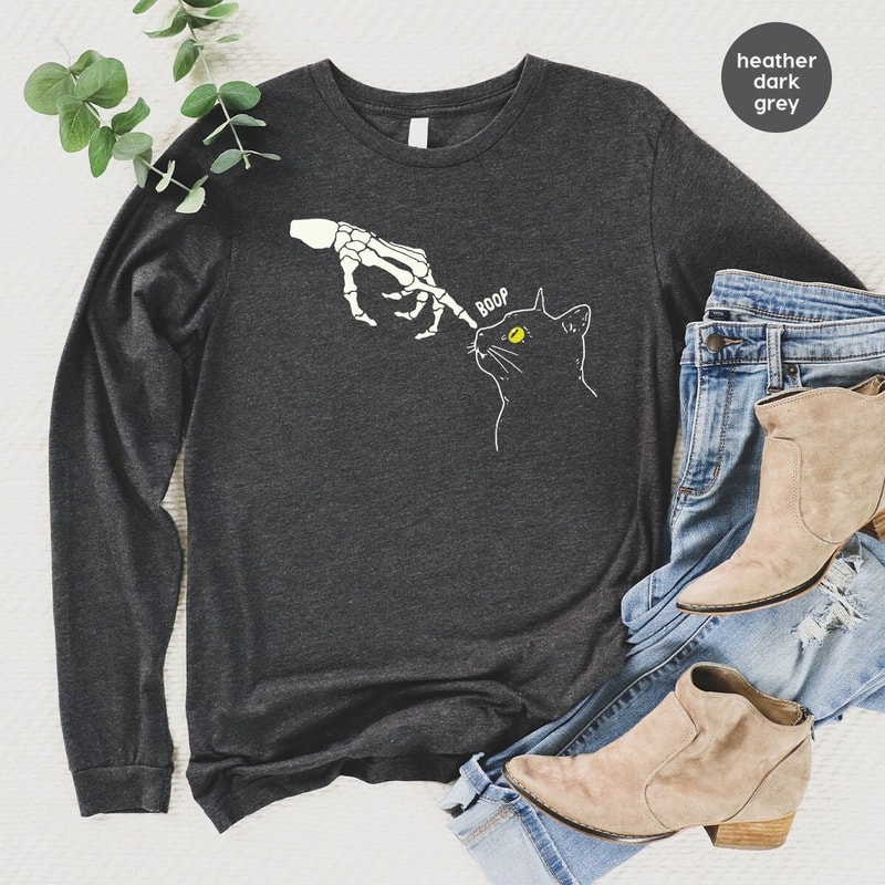 Skeleton Hand Cute Cat Graphic Hoodies for Women, Funny Skeleton Cat Halloween Long Sleeve Shirts, Unisex Halloween Skeleton Sweatshirts - 1.jpg