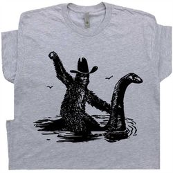 bigfoot t shirt riding loch ness monster shirts cool sasquatch rodeo graphic cryptozoology weird yeti country western co