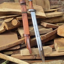 Handmade vintage viking sword with engraved wood handle and engraved sheath.