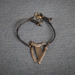 harp bracelet on cotton cord. celtic harp bracelet. female present.  musical instrument jewelry. tiny bracelet.