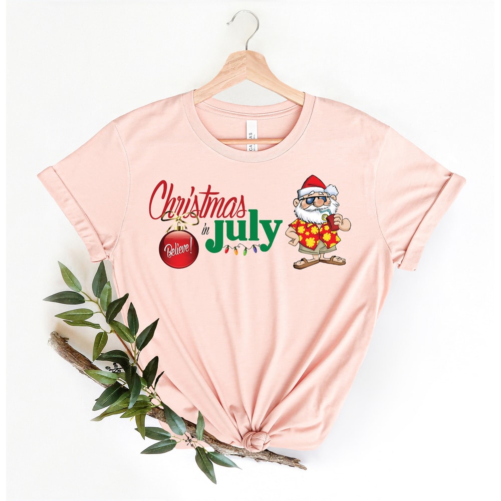 Christmas in July Tee, Santa At The Beach, Xmas In Summer Tee, Holiday Santa Claus Tee, Family Summer Vacation Tee, Tropical Christmas Tee - 1.jpg