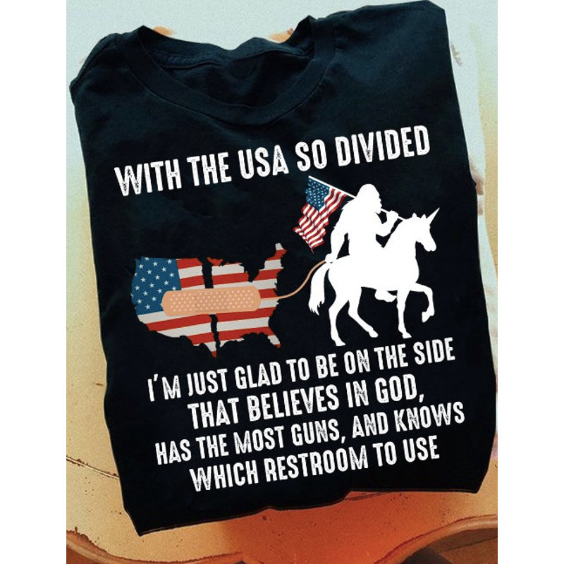With The USA So Divided I'm Just Glad To Be On The Side That Believes In God T-Shirt, Bigfoot Sasquatch American Flag Riding Unicorn Shirt - 1.jpg