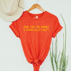 the original* here for the drinks & travis kelce's butt , kansas city pride shirt , unisex short sleeved shirt , made to