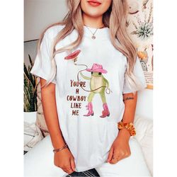 swiftie merch, cowboy like me shirt, cowboy shirt, evermore,cowboy frog meme