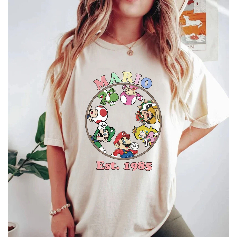 Mario Est 1985 Comfort ColorsĀ® Shirt, Princess Peach Shirt, Super Mario Shirt, Princess Peach And Friends Shirt, Super Mario Group Shirt - 1.jpg
