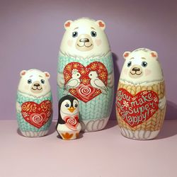 A love bear matryoshka doll. Set of 4 hand-painted wooden dolls . Cute polar bears and a penguin .gift for a loved on