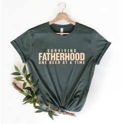 surviving fatherhood one beer at a time shirt, husband gift, father's day gift, gift for him, gift for dad, new dad shir