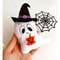 Felt toy - ghost in pointed black hat with orange Halloween pumpkin in the author's hand