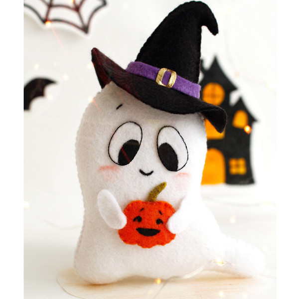 Felt toy - ghost in pointed black hat with orange Halloween pumpkin left side view