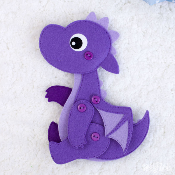 felt toy dragon is looking up