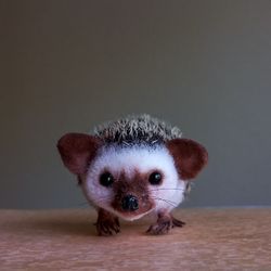 Cute toy hedgehog. Realistic replica animal.