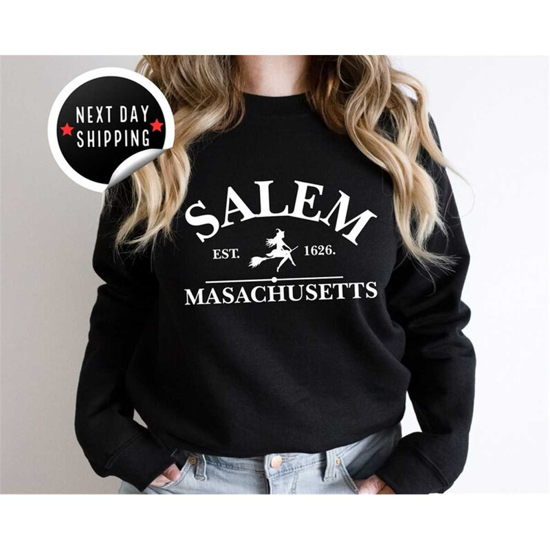 MR-2582023181356-salem-massachusetts-crewneck-halloween-sweatshirt-on-sand-image-1.jpg