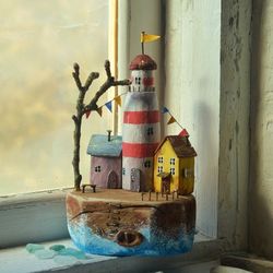 Driftwood Art island with a lighthouse &houses,sea wood desktop composition,  natural materials, eco marine style