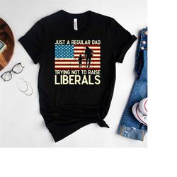 just a regular dad trying not to raise liberals shirt with american flag background,republican dad tee,anti liberal dad