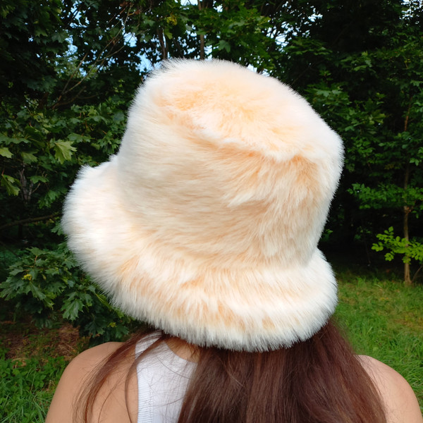 Apricot bucket hat made of faux fur. A fluffy hat for a festival, a party. Cute fuzzy bucket hats. Fluffy warm hat.