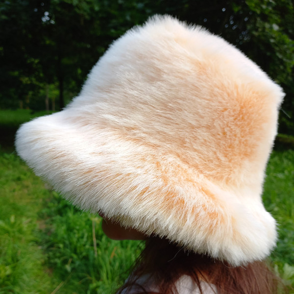 Apricot bucket hat made of faux fur. A fluffy hat for a festival, a party. Cute fuzzy bucket hats. Fluffy warm hat.