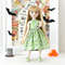 A 14-inch Ruby Red Fashion Friends doll in a green dress with skulls.