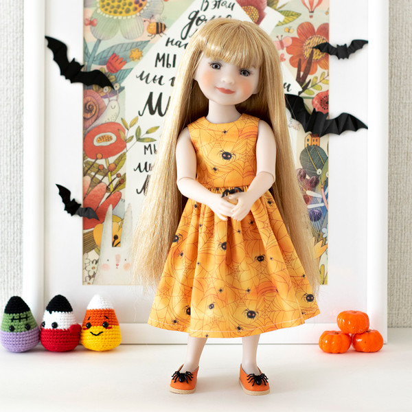 Ruby Red Fashion Friends doll in an orange dress with spiders and cobwebs for Halloween