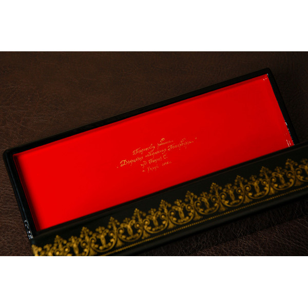 Golden sign on lacquered jewelry box
