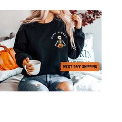 stay spooky t-shirt, minimal halloween t-shirt, skeleton pocket sweatshirt, skeleton graphic t-shirt, halloween 2023 t-s