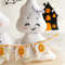 Felt ghost boy and girl with BOO garland in the hands standing against the background of painted Halloween decorations, close-up girl ghost view