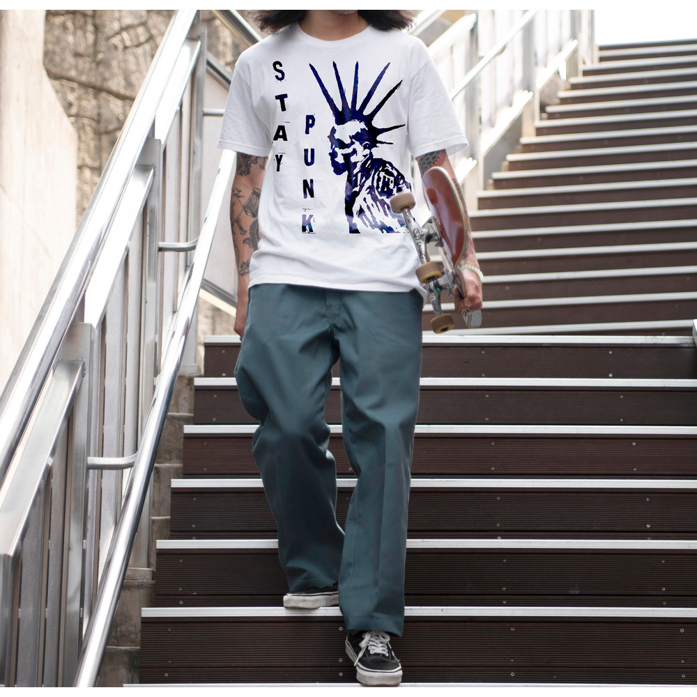 asian-man-holding-his-skateboard-while-walking-stairs.jpg