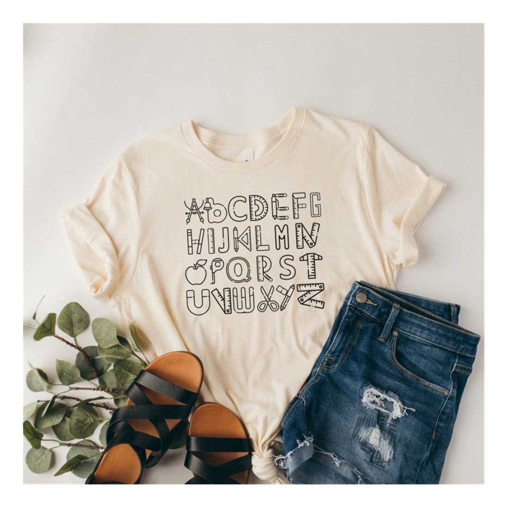 MR-2292023162412-alphabet-doodle-teacher-tshirt-teaching-shirt-first-grade-image-1.jpg