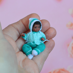 Miniature doll child in 12th scales. A baby for the dollhouse. Baby in a blue suit.