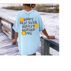 don't trip over what's behind you, aesthetic crewneck, oversized tshirt, preppy shirts, sayings on back, trendy tshirt