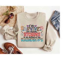 i have survived too many storms to be bothered by raindrops cancer warrior shirt gift for cancer survivor, breast cancer